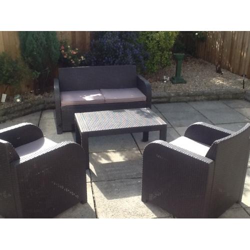 Rattan brown furniture with dark beige cusions