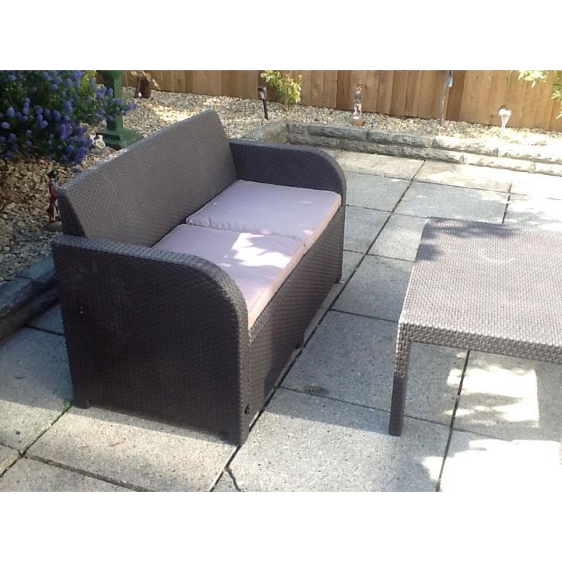 Rattan brown furniture with dark beige cusions