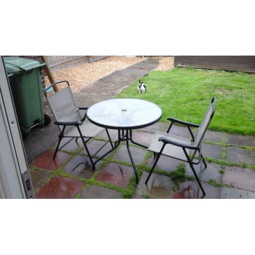 Glass top patio table and two chairs