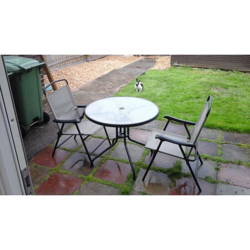 Glass top patio table and two chairs