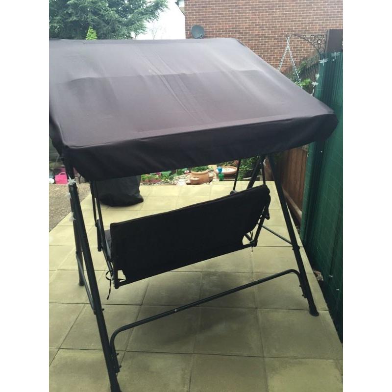 BLACK TWO SEATER HAMMOCK WITH CUSHION. ALSO SPARE BRAND NEW SEAT CUSHION AND A RAIN COVER