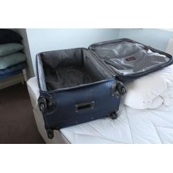 A Large SUITCASE on four castors- Used only once courtesy Celebrity Cruises