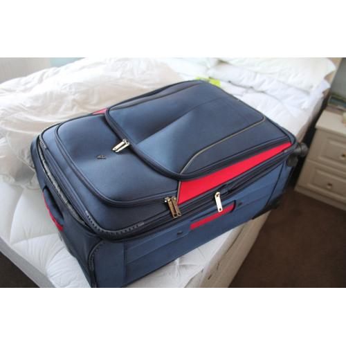 A Large SUITCASE on four castors- Used only once courtesy Celebrity Cruises