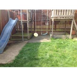 Children's climbing frame with slide and swings