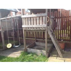 Children's climbing frame with slide and swings