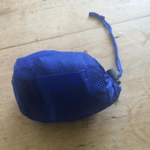 Kids blue waterproof jacket in a bag