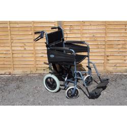 Wheelchair with foldaway footrests & locking brakes