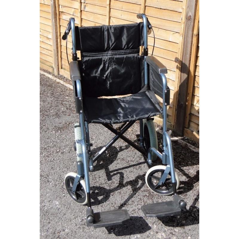 Wheelchair with foldaway footrests & locking brakes