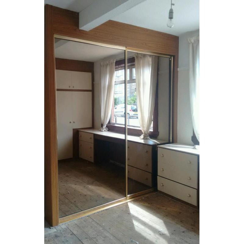 Free built in bedroom storage with large tinted mirrors