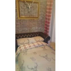 Beautiful brown leather chesterfield sofa bed.