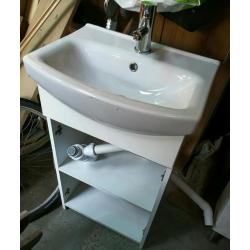 Compact sink in vanity unit, with mixer tap inlet and waste pipes