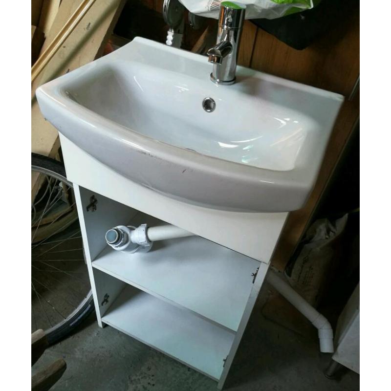 Compact sink in vanity unit, with mixer tap inlet and waste pipes