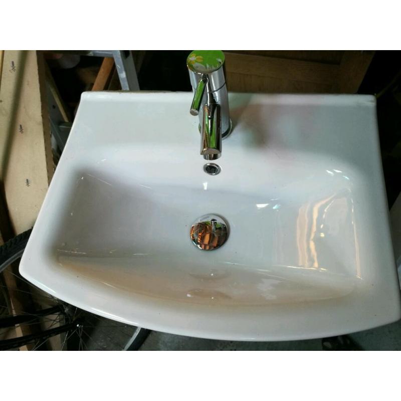 Compact sink in vanity unit, with mixer tap inlet and waste pipes