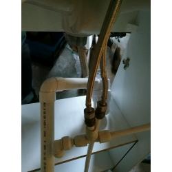 Compact sink in vanity unit, with mixer tap inlet and waste pipes