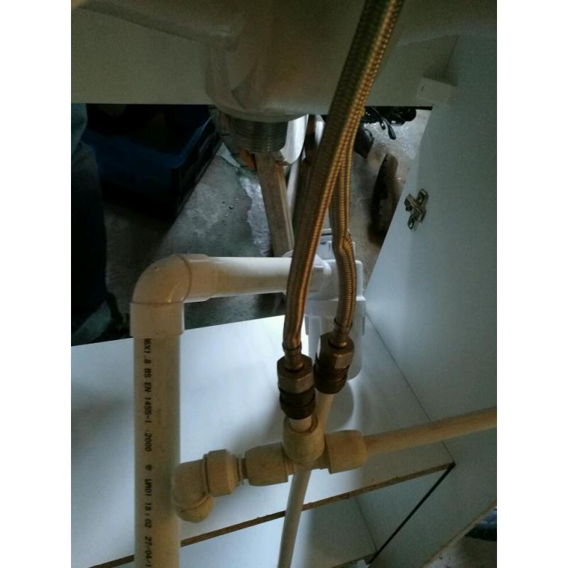 Compact sink in vanity unit, with mixer tap inlet and waste pipes