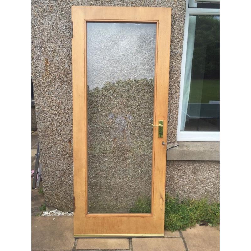 Solid wood door with safety glass
