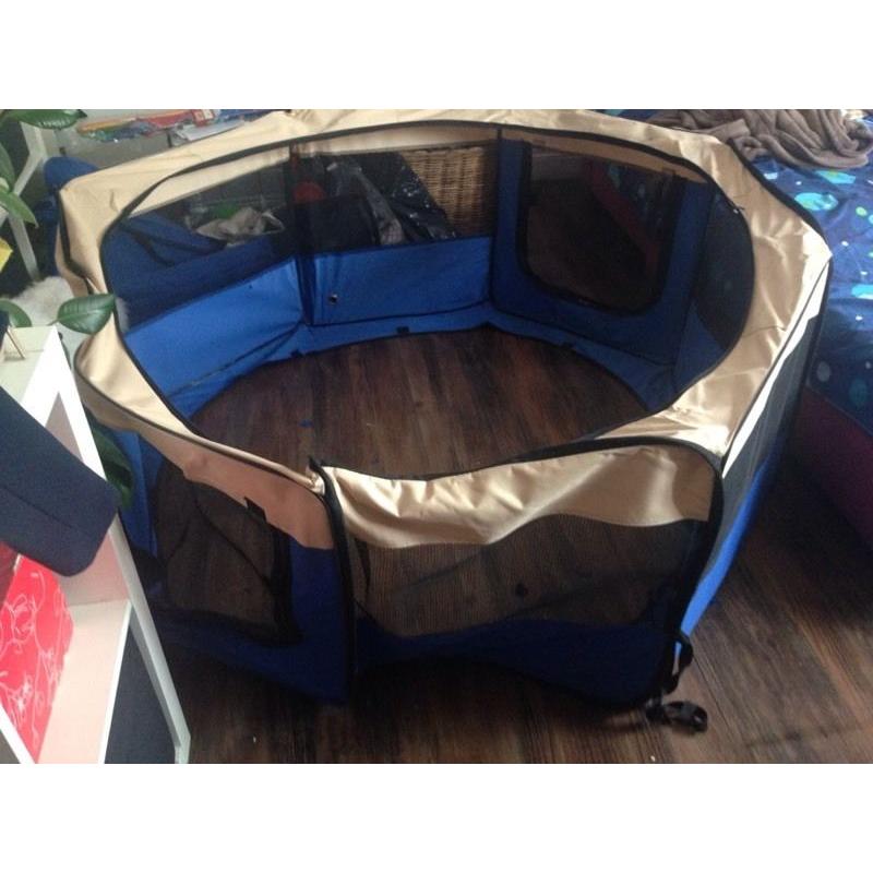 Portable blue and beige fabric play pen for a dog, cat, rabbit or Guinea pig.