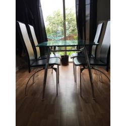 Glass table with 4 black chairs