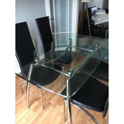 Glass table with 4 black chairs