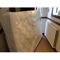 Unused double mattress in packaging