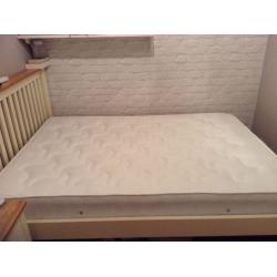 Unused double mattress in packaging