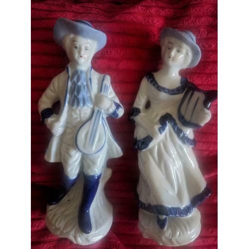 PORCELAIN VINTAGE MAN AND LADY FIGURINES .