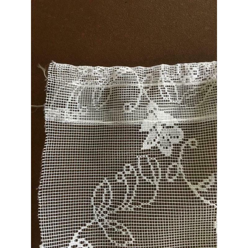 Two white net curtains